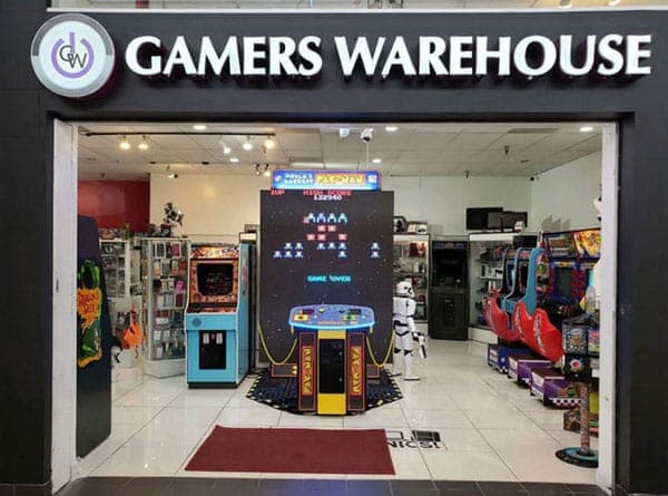 The entrance to Gamers Warehouse inside Tucson Mall, showing the store's signage and arcade machines