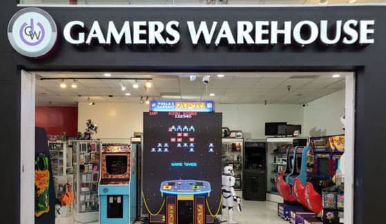 The Gamers Warehouse storefront inside Tucson Mall, with arcade cabinets and display cases visible through the entrance
